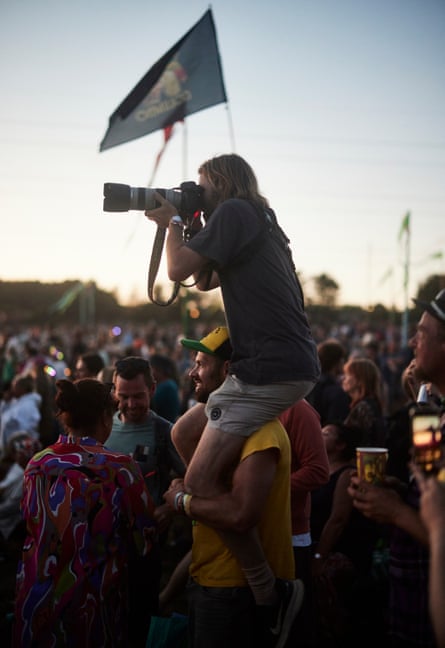 Guardian photographer Jonny Weeks gets a leg up from a kind punter to take pictures of Guns N’ Roses.