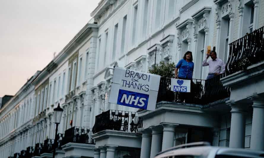 People stand on their balcony in central London