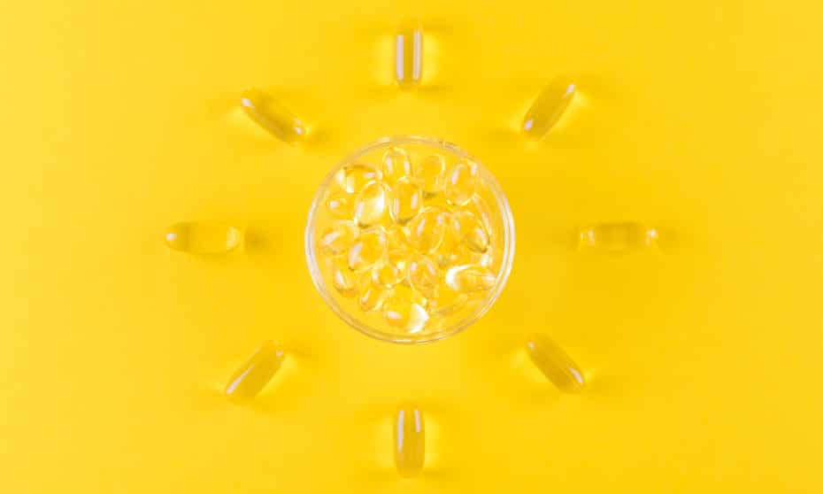 golden omega capsules like sun on yellow background