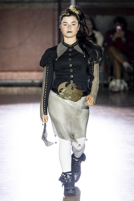 A model walks the Chopova Lowena runway in a black top with chainmail skirt and sleeves