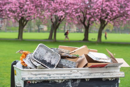 A bin overflowing with disposable barbecues