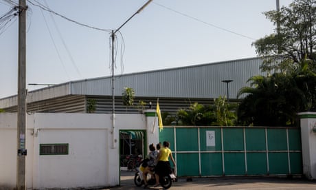 People ride into the compound of the VKG factory in Mae Sot, Thailand.