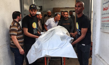 Men transporting a bodybag containing one of the World Central Kitchen aid workers killed by Israel Defense Forces