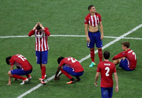 Atletico players react in despair after Ronaldo’s penalty.