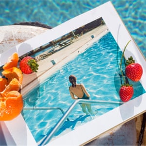 Fruit sits on a framed image of a woman in a pool