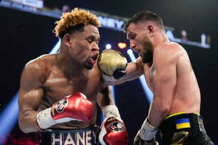 Devin Haney, left, takes a punch from Vasiliy Lomachenko during their undisputed lightweight championship match on Saturday night.