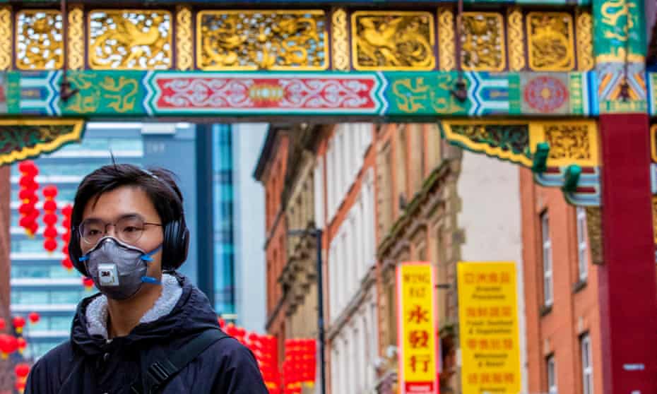 A member of the Chinese community in Manchester wearing a face mask. 