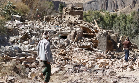 People walk on the rubble of a house destroyed by a Saudi-led air strike in Sanaa, Yemen