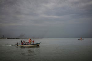 Boats carry papier-mache statues of Ganesh