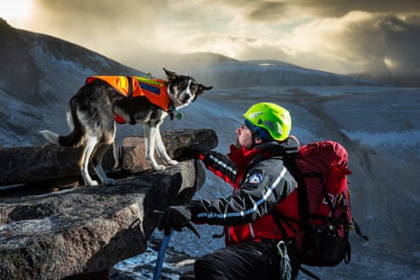 Stu McIntyre (44 years) with his dog Pippa seen above Coire an Lochain, Cairngorms