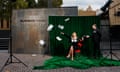 Artist Kirsha Kaechele performing outside MONA with props from her Ladies Lounge installation, following a court order to admit men to the lounge