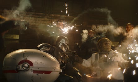Sparks fly as The Mandalorian (Pedro Pascal) meets Gor Koresh (in background, center).