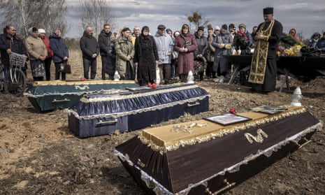 Friends and family attend funeral services for Mark Bobrovytsky, 59, Halyna Bobrovytskyi, 59, and Maksym Bobrovytsky, 25 at a cemetery in Borodyanka, Ukriane on Saturday, April 23, 2022. They died in they apartment in Borodyanka after a Russian air strike.