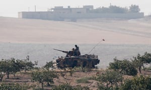 Turkish tanks patrol near the Turkish-Syria border.