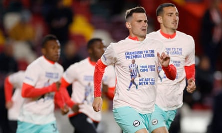 Pascal Gross (front) and his Brighton teammates warm up in T-shirts paying tribute to Enock Mwepu