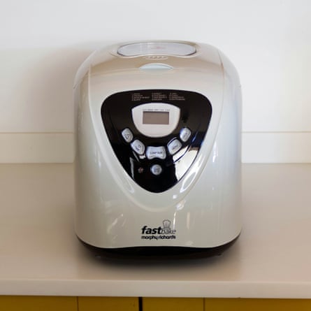 A silver and black Morphy Richards FastBake bread maker sits on a kitchen counter