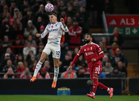 Lucas Digne beats Mo Salah to a header.