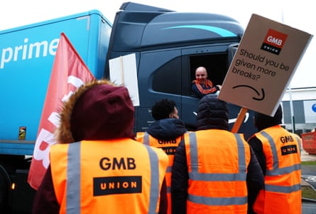 Striking Amazon workers speak to a lorry driver at a picket line during a strike over pay at the Amazon.com Inc. fulfilment centre in Coventry, UK, on Tuesday, Feb. 28, 2023