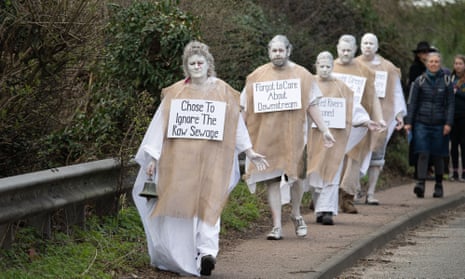 XR Penitents during a protest outside the Thames Water Little Marlow Sewage Treatment Works today in Buckinghamshire about Thames Water and their storm discharges of sewage into the River Thames. The ghostly figures of the Penitents walked from the sewage works to the River Thames wearing sin placards to help raise public awareness of sewage discharges.
