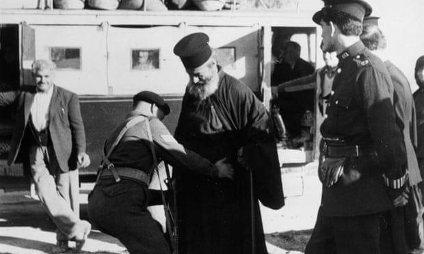 British soldiers search a Greek Orthodox priest in 1955.