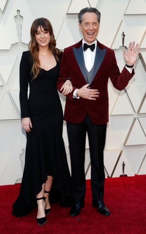 Richard E Grant wore red velvet tux jacket with clashing lapels. The actor, who was nominated for Best Supporting Actor for his role in Can You Ever Forgive Me?, was joined by his daughter Olivia, who wore a long-sleeve black dress