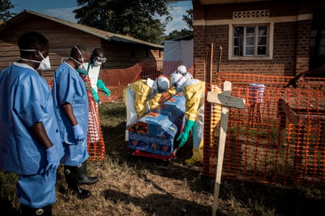 Medical workers disinfect a coffin at an Ebola treatment centre in Beni