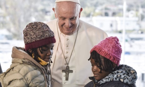 Pope Francis greets two girls at a migrants centre in Mytilene on the island of Lesbos, Greece, in 2021.