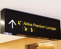 An airport sign to a premium lounge
