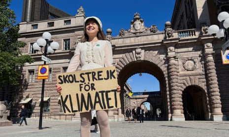Greta Thunberg stands outside the Swedish parliament in Stockholm during her last weekly school strike
