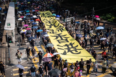 Protesters carry a banner referring to the song Glory to Hong Kong on Tuesday.