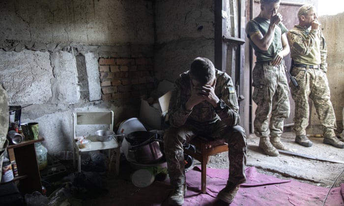 Ukrainian servicemen take cover underground in a cellar during heavy shelling in Siversk, Ukraine.