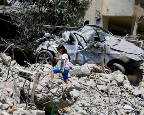 A girl amid destroyed buildings in Deir Qanoun En Nahr, southern Lebanon, on Monday
