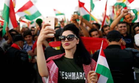 A woman shows her support for the 25 September independence poll for Kurdish northern Iraq in Erbil.