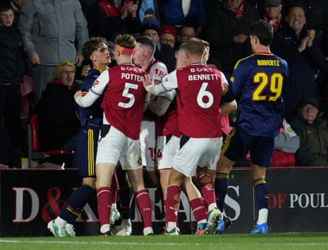 Arsenal's Max Dowman clashes with Fleetwood Town's Finley Potter during a match