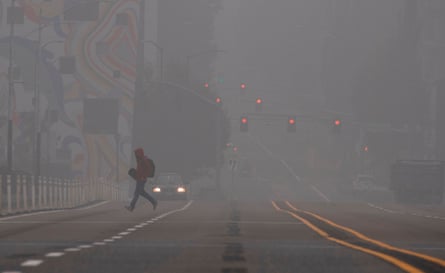 A man crosses a street in downtown Portland, Oregon where air quality due to smoke from wildfires was measured to be amongst the worst in the world, September 14, 2020