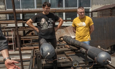 Engineers Vitaliy Korniychuk, left, and Akim Kleymenev get ready to test prototype engines.