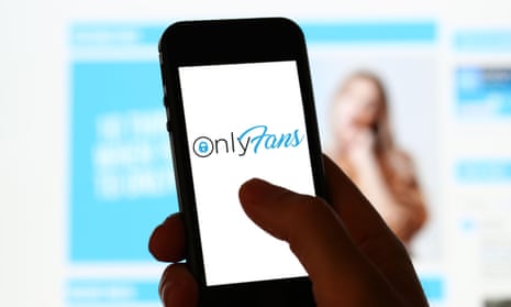 A man looking at OnlyFans website on a mobile phone