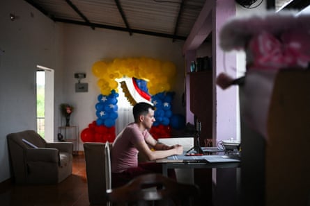 A man sits at a desk in front of a computer