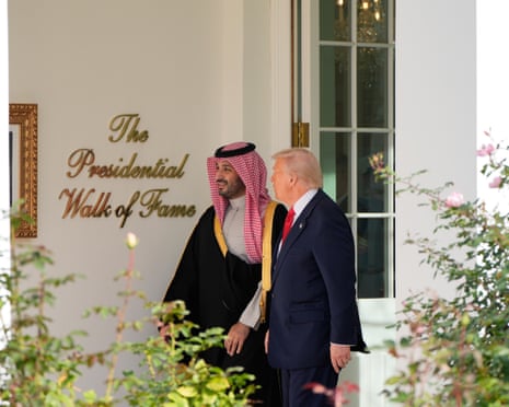 Trump and bin Salman walk along the ‘Presidential Walk of Fame’.