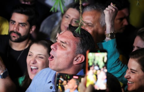 Man celebrates as people take pictures