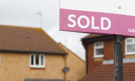 Estate agent's sold sign outside a property