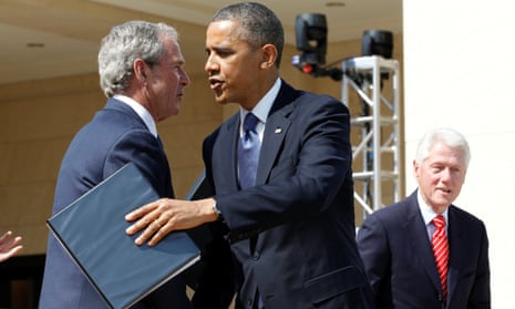 Barack Obama embraces George W Bush in 2013.