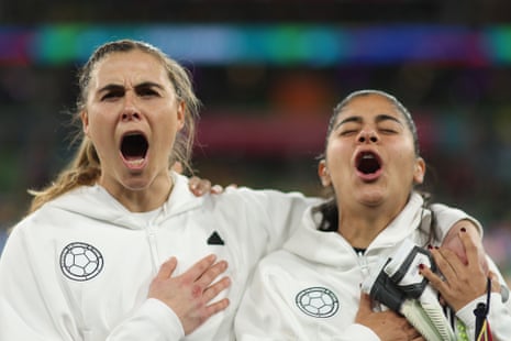 Catalina Perez and Catalina Usme of Colombia sing the national anthem prior to the 2023 Women’s World Cup round of 16 match between Colombia and Jamaica.