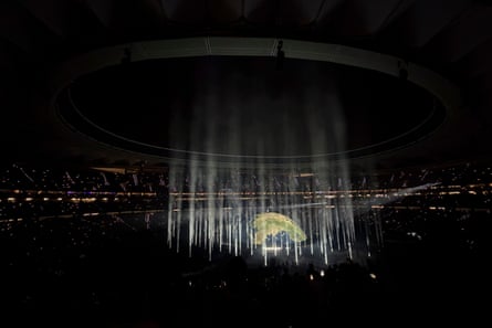 Kanye West, or Ye, performs on a stage designed to look like a globe, with beamed lights around it, in the largest concert venue of Riyadh Air Metropolitano stadium in Madrid, Spain.