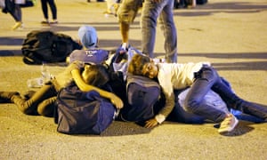 Children rest on the ground at Piraeus harbour in Greece.