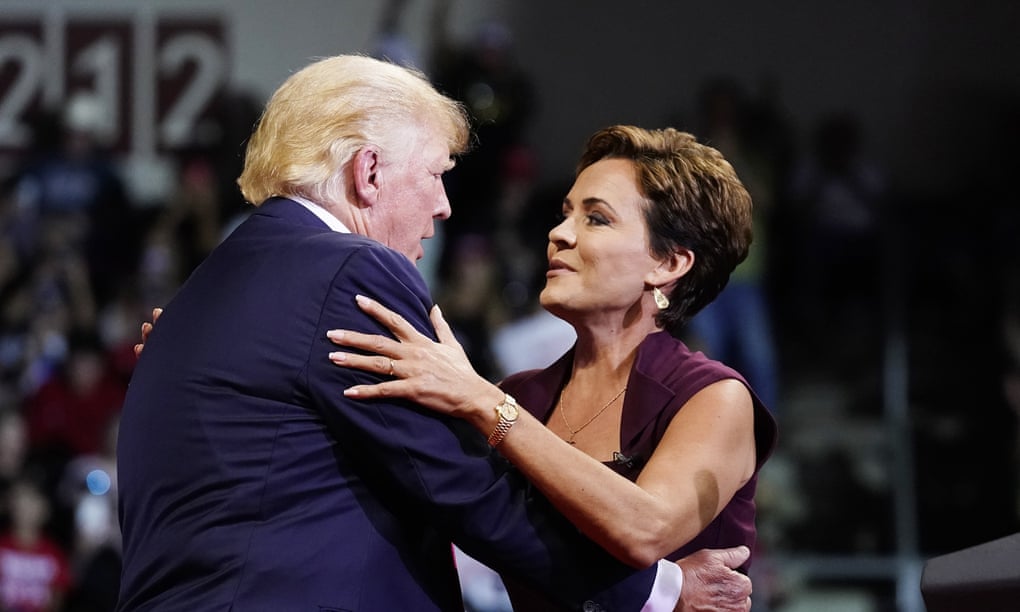 Kari Lake is embraced by Donald Trump at a rally in Prescott last week. Lake has falsely said Biden did not win in Arizona, and called the election ‘corrupt’.