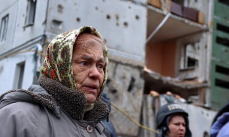 A woman outside a damaged apartment building after the liberation of the city from Russian invaders, Chernihiv, northern Ukraine.