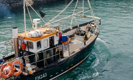 Fisherman Jonathan Fletcher heads out to sea in his boat in Porthleven