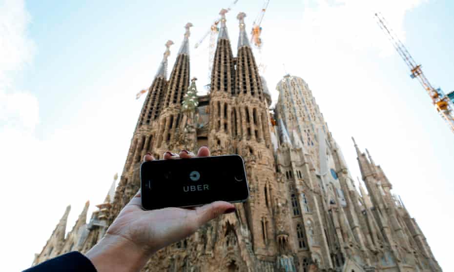 A person using the Uber app outside the Sagrada Familia in Barcelona.