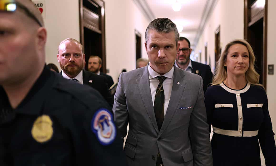 Pete Hegseth, Donald Trump’s nominee for secretary of defense, and his wife, Jennifer Rauchet, move between meetings with senators on Thursday in Washington DC
